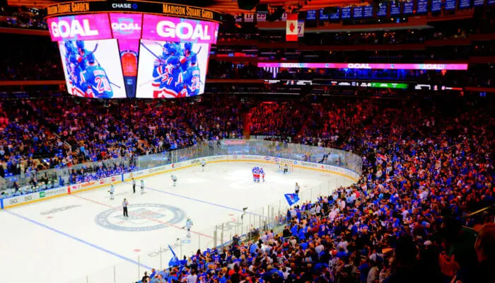 A sleek and modern mobile app interface showcasing the key features of the NHL's official application. In the foreground, a clean and intuitive dashboard displays live scores, game schedules, and team standings against a backdrop of muted grays and blues. The middle ground features a detailed game view, allowing users to watch live matches with real-time stats and highlights. In the background, subtle NHL team logos and branded elements create a sense of immersion and brand identity. The lighting is soft and even, creating a sophisticated and professional atmosphere. The camera angle is slightly elevated, providing a comprehensive overview of the app's functionality and design.